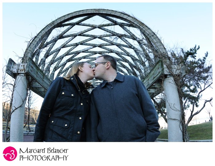 Kissing under the arch of the Christopher Columbus Park, Boston