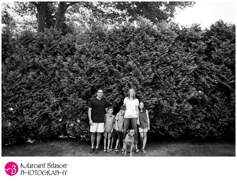 Whole family standing in front of tall bushes, Winchester, MA