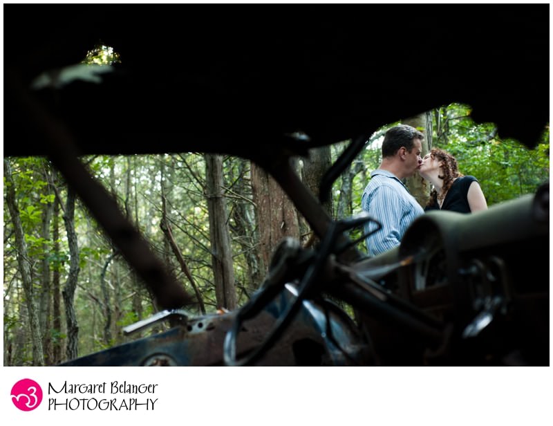 Couple kissing through the window of a broken car, John Chafee Nature Preserve