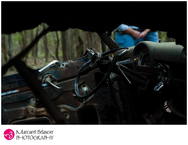 Couple through the window of a wrecked car, John Chafee Nature Preserve