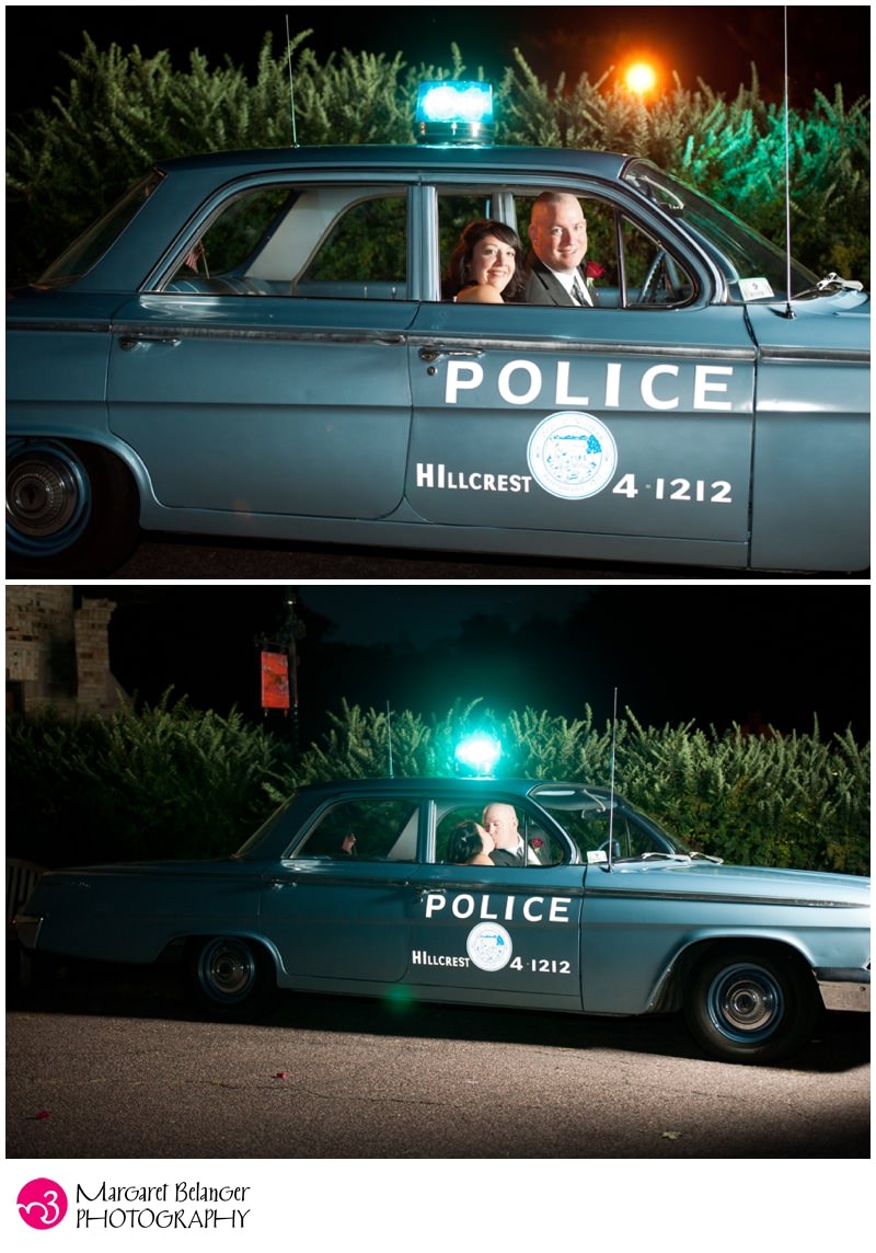 Bride and groom inside vintage police car, Larz Anderson Auto Museum
