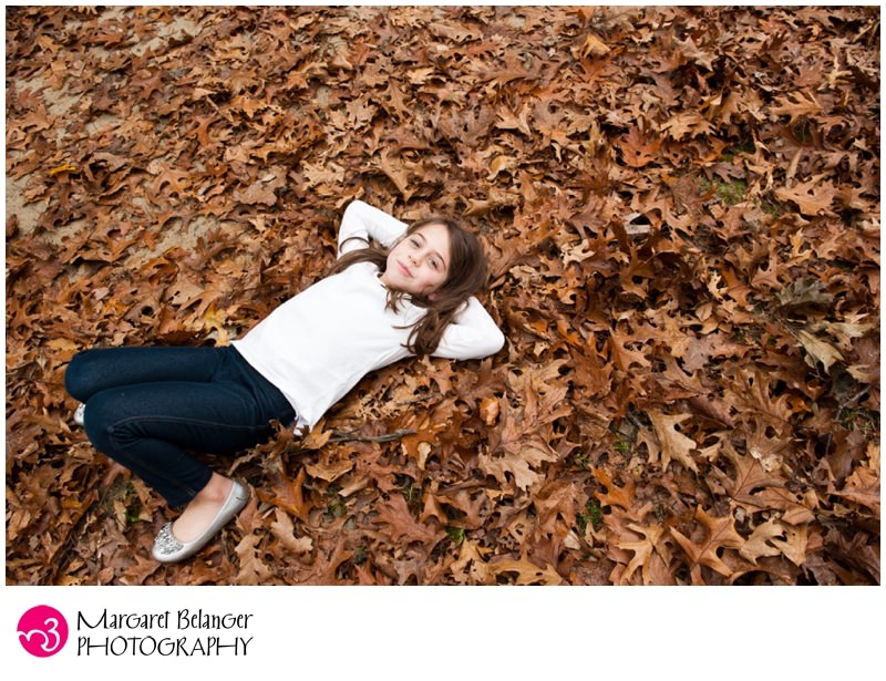Minuteman National Park, Lincoln, MA, little girl lying down in the fall leaves