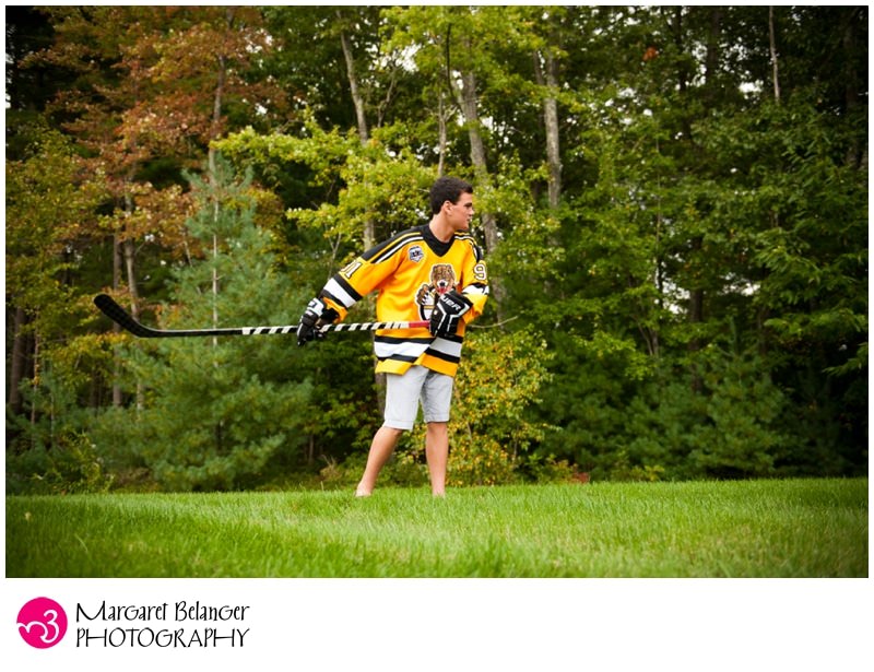 Boy swinging hockey stick, Hopkinton senior portrait session