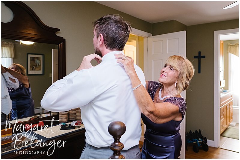Mom adjusting her son's collar as he gets ready for his Bittersweet Farm wedding