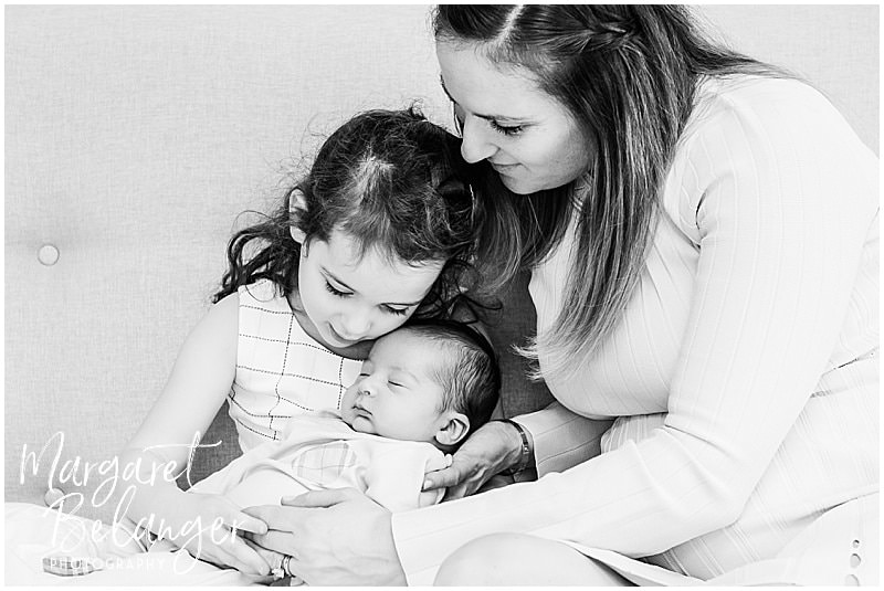 Brookline newborn session, mom helping big sister hold new brother