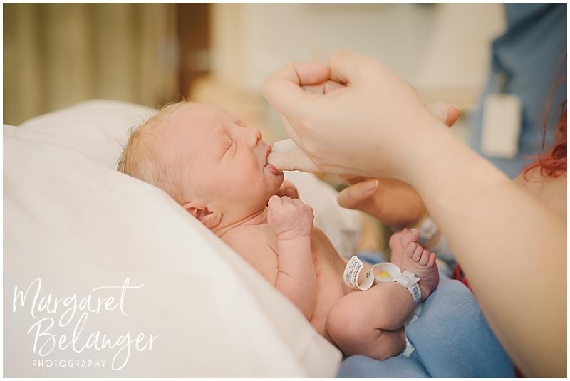 Fresh 48 newborn session at Emerson hospital, mom feeding new baby with a finger and a syringe