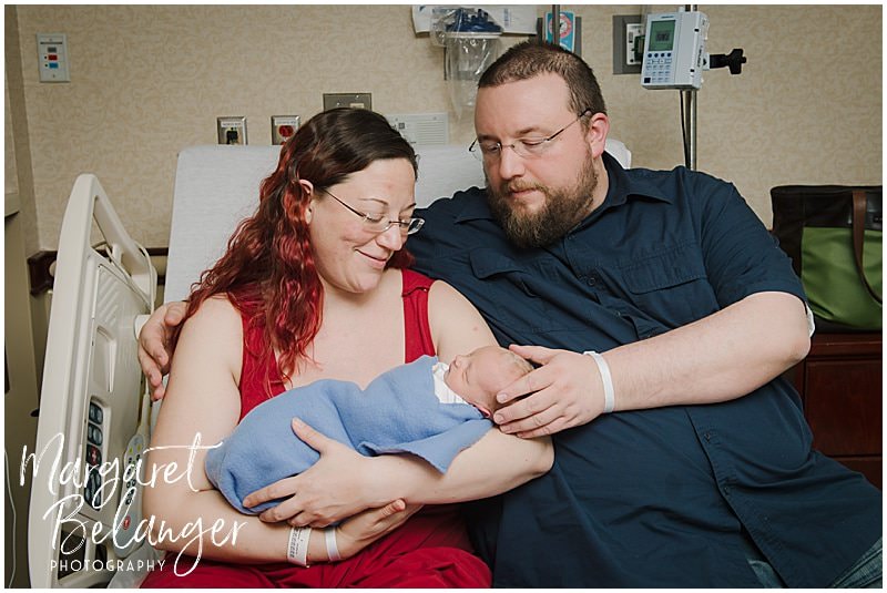 Fresh 48 newborn session at Emerson hospital, mom and dad holding new baby on hospital bed