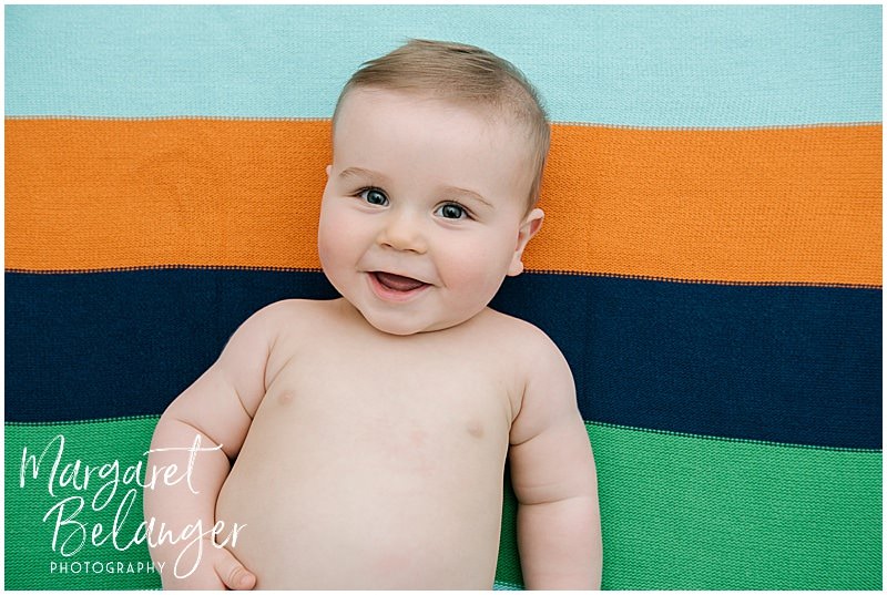 7 month old on a striped blanket at his Rhode Island family session