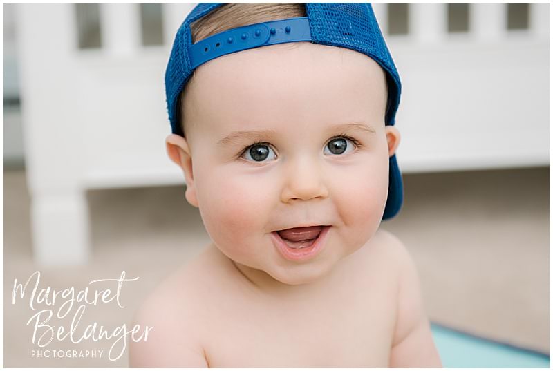 7 month old in a backwards baseball cap at his Rhode Island family session