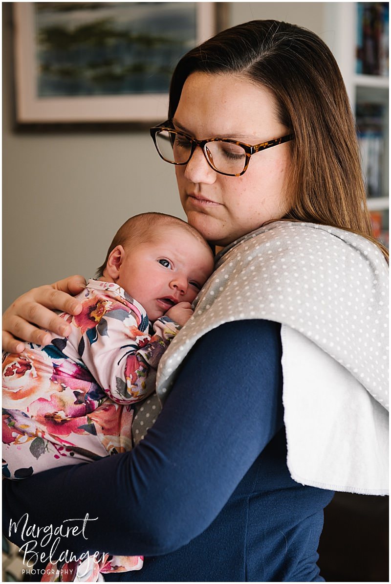 South Shore newborn session, mom holding baby girl on her shoulder