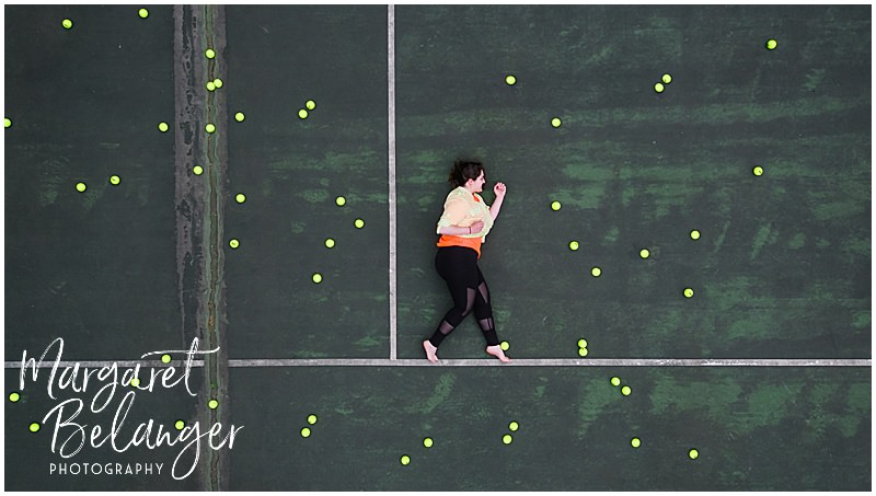 Drone portrait of woman walking on a tennis court