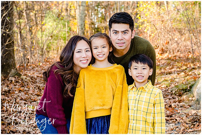Bright fall family photo of parents and their two children