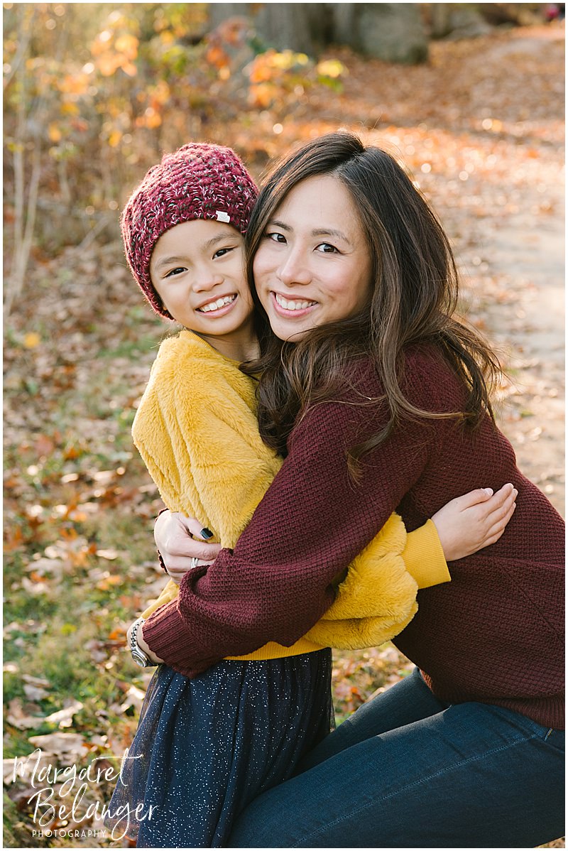 Fall photo of mother and daughter hugging at Minute Man National Park