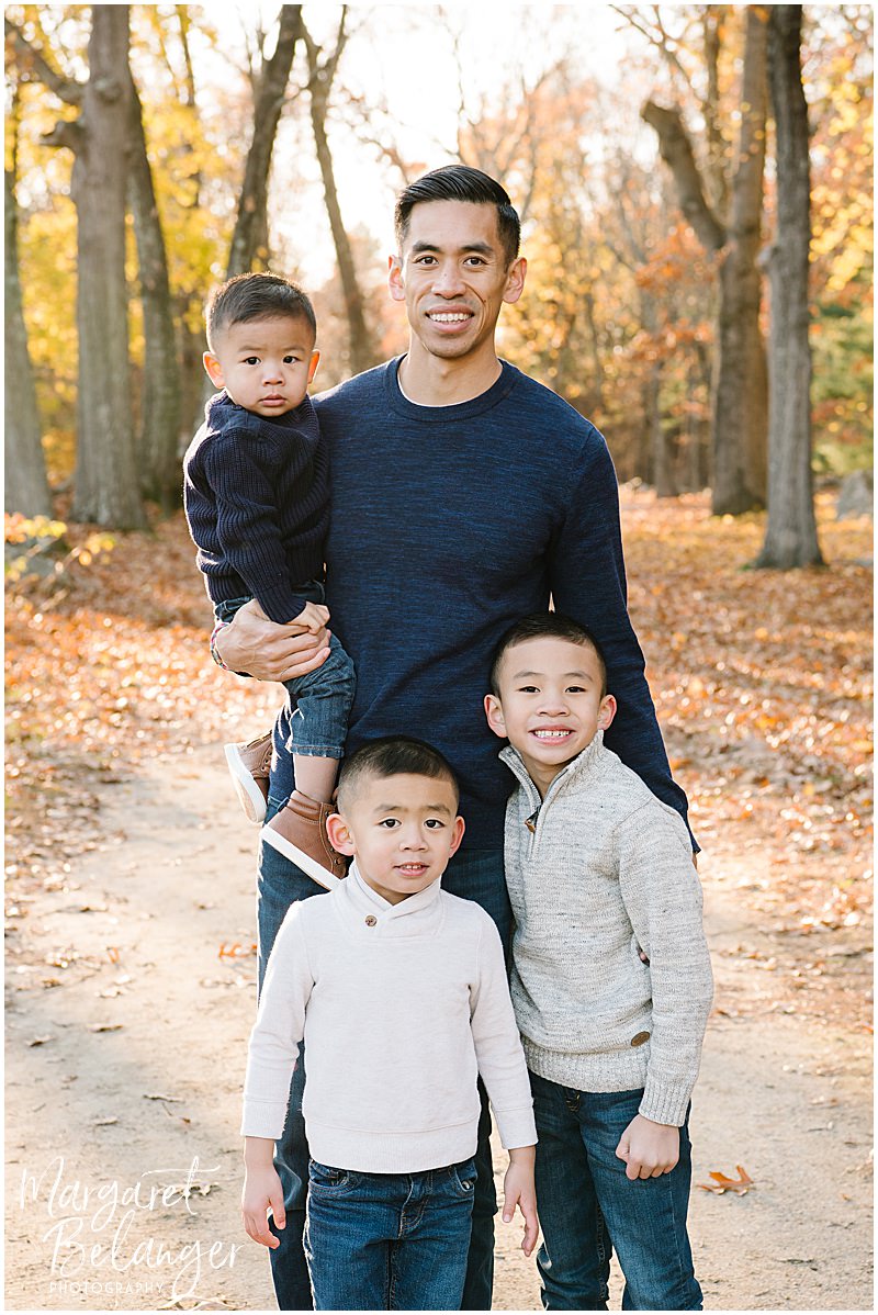 Fall family photo of a Dad and his three sons at Minute Man National Park