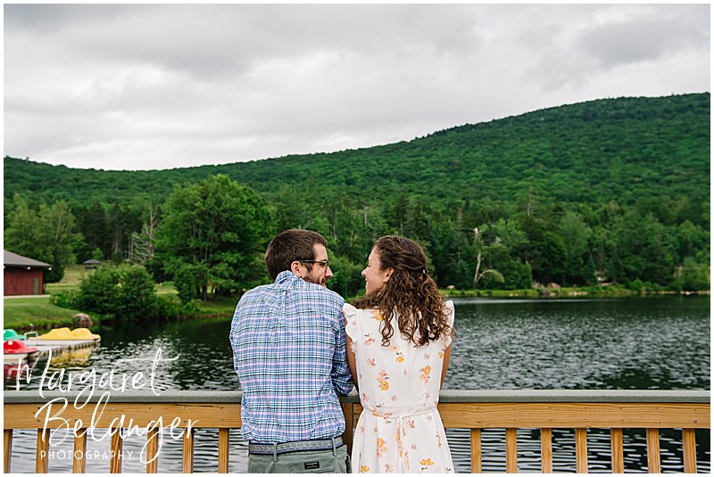 Couple pose on a bridge overlooking the Waterville Valley mountains