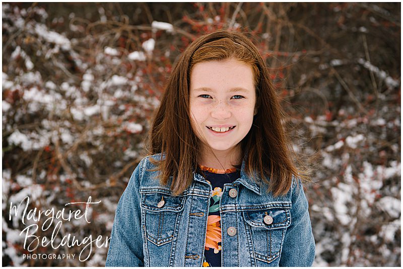 Portrait of a tween in the snow during a winter family session at Minute Man National Park in Lincoln.