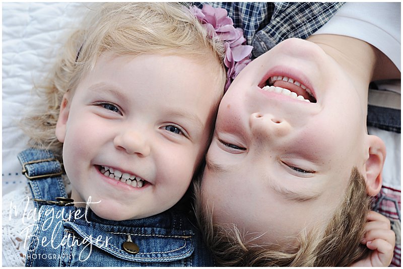 Two little kids with their faces smooshed together during their Newton family session.