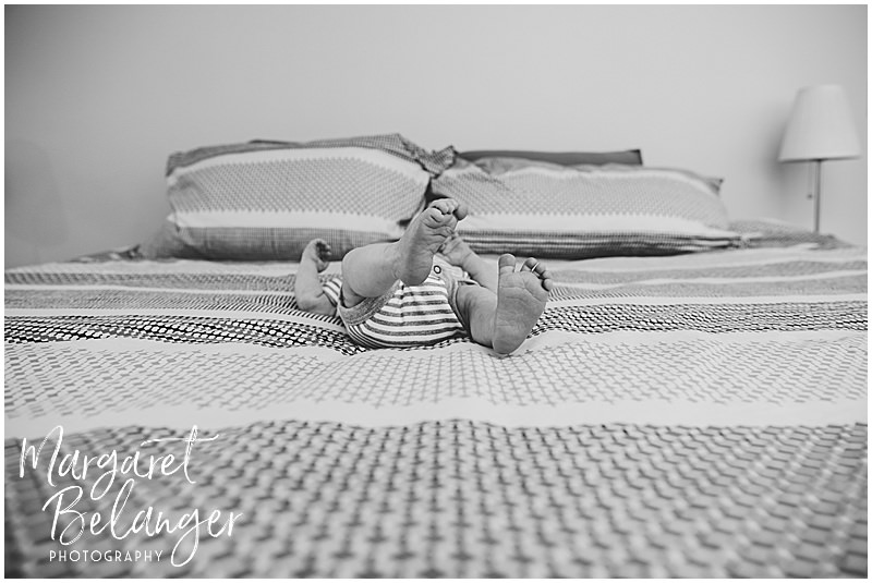 Black and white photo of a newborn boy's feet at a Winchester, MA newborn photo session