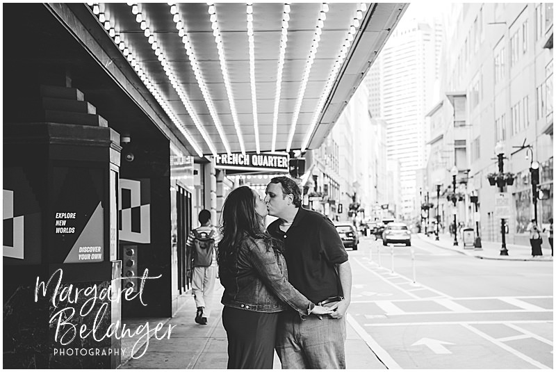 Black and white photo of a couple kissing under the Paramount Theater marquee in Boston's Theater District.