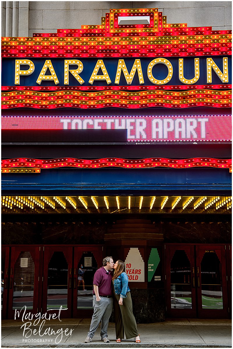 A couple kissing underneath the Paramount Theater marquee in Boston's Theater District.