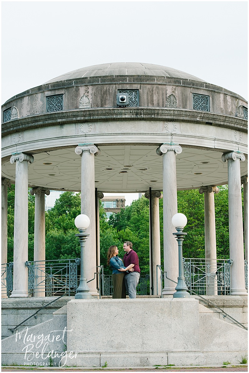 Couple posing in the big gazebo on Boston Common during their engagement session.