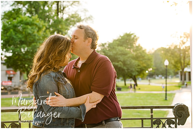 A man kisses his fiancee's forehead during their Boston Common engagement session.
