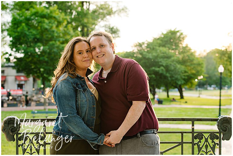 Couple smiles for the camera on the gazebo in Boston Common during golden hour.