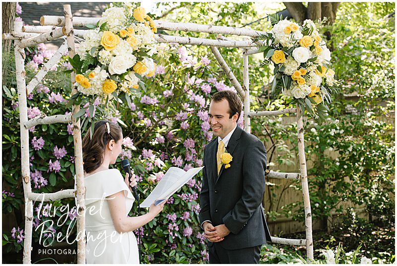 Bride and groom exchanging vows during a backyard wedding in Winchester, MA.