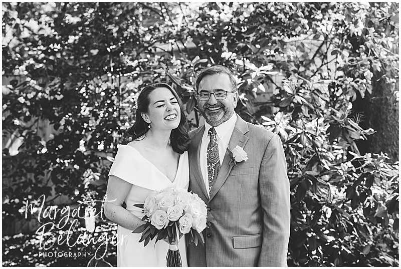 Black and white photo of the bride laughing with her father at a Winchester, MA backyard wedding.