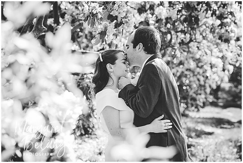 Black and white photo of groom kissing bride's forehead in Winchester Center.