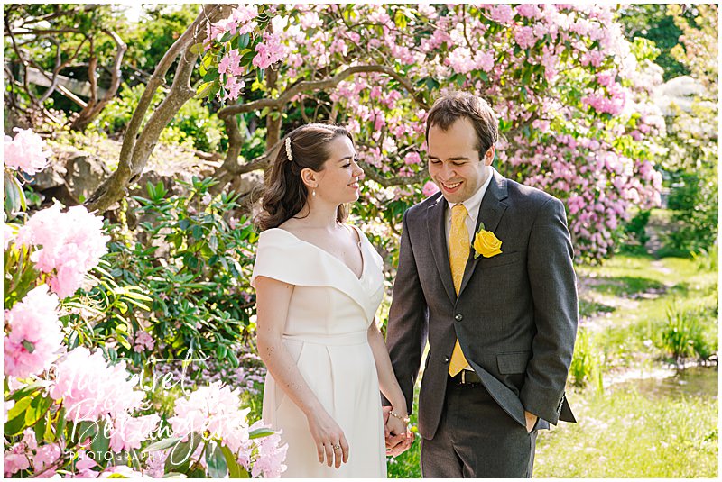 Bride and groom portraits among the flowers in Winchester Center.