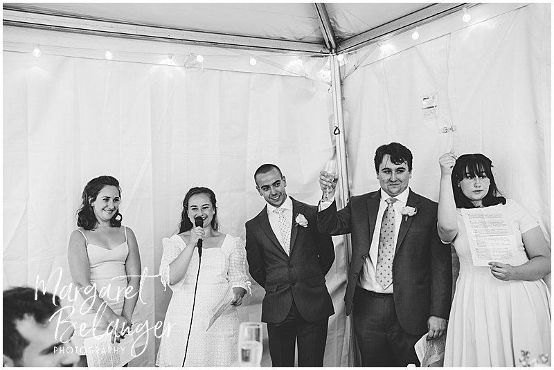 Bride's siblings give a toast at a backyard wedding in Winchester, MA.