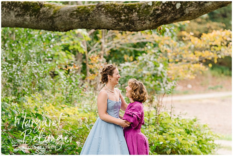Brides laugh together on the grounds of Allandale Farm in Brookline