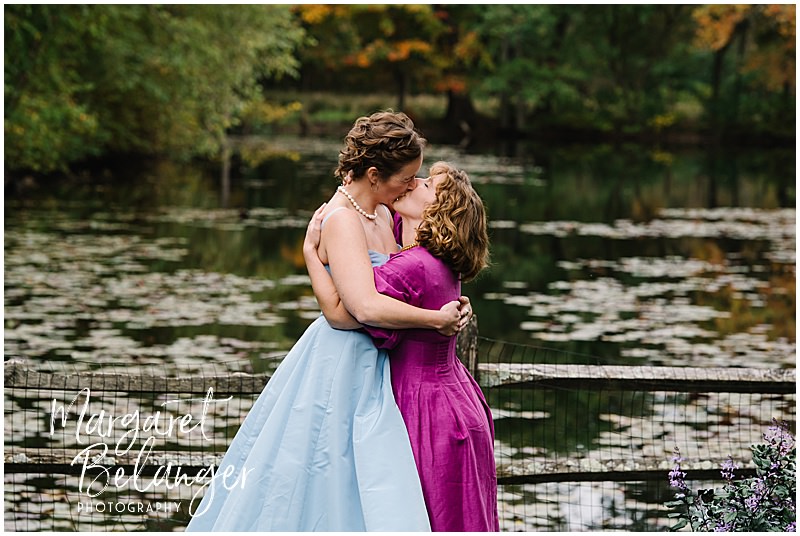 Brides share their first kiss at the end of their wedding ceremony.